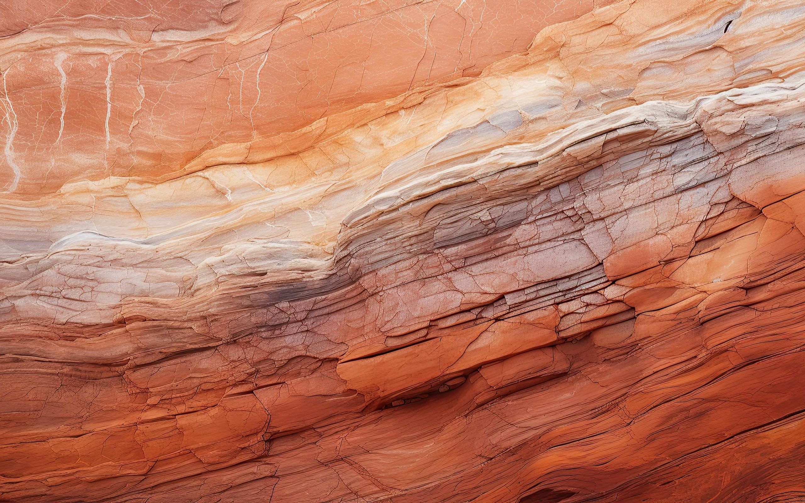 Layers of red and white sandstone with natural flowing patterns.