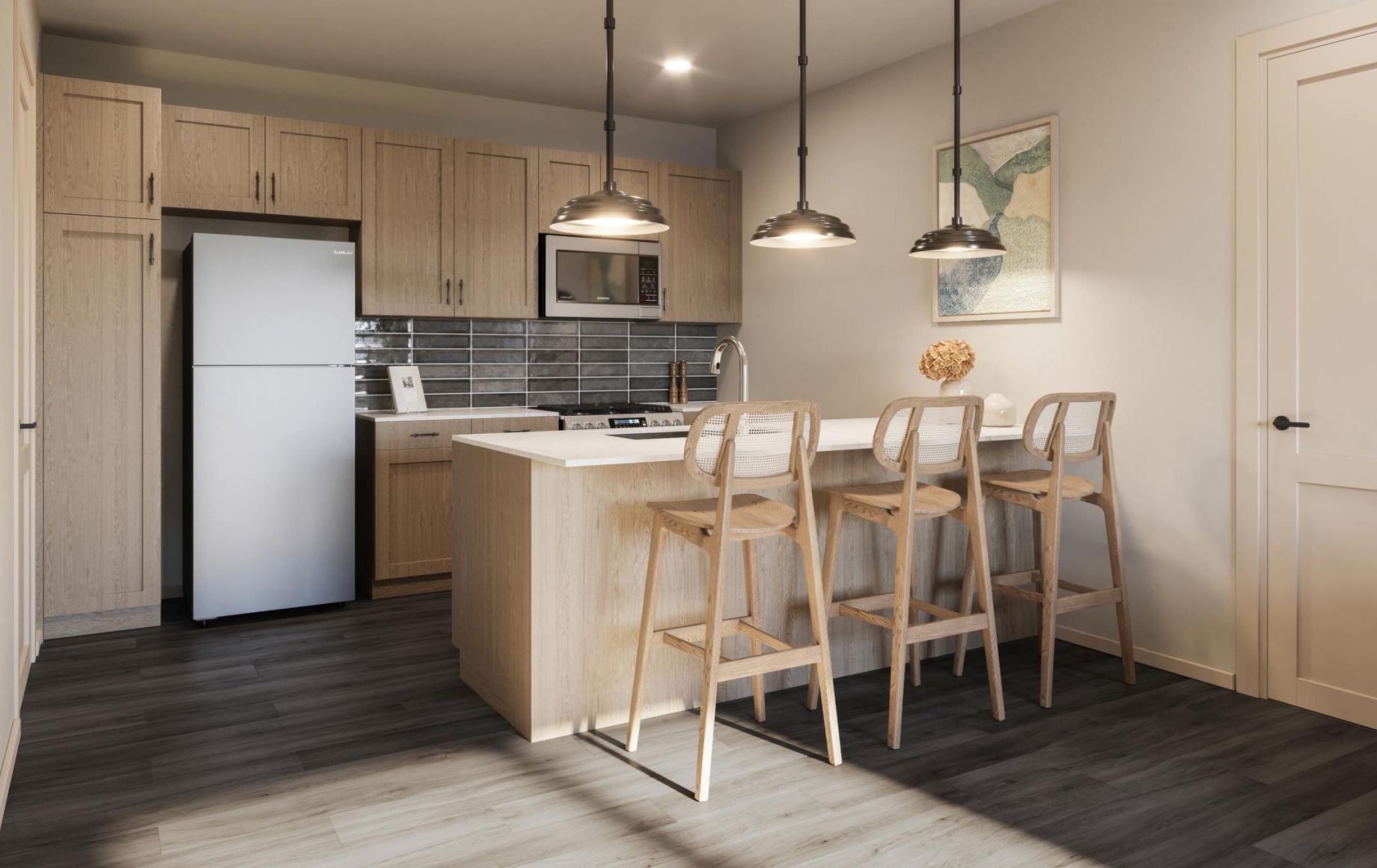 Modern kitchen with light wood cabinets, island, three bar stools, pendant lights, and stainless steel appliances.